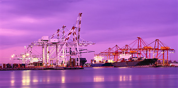 Container ships at Melbourne docks at dusk.